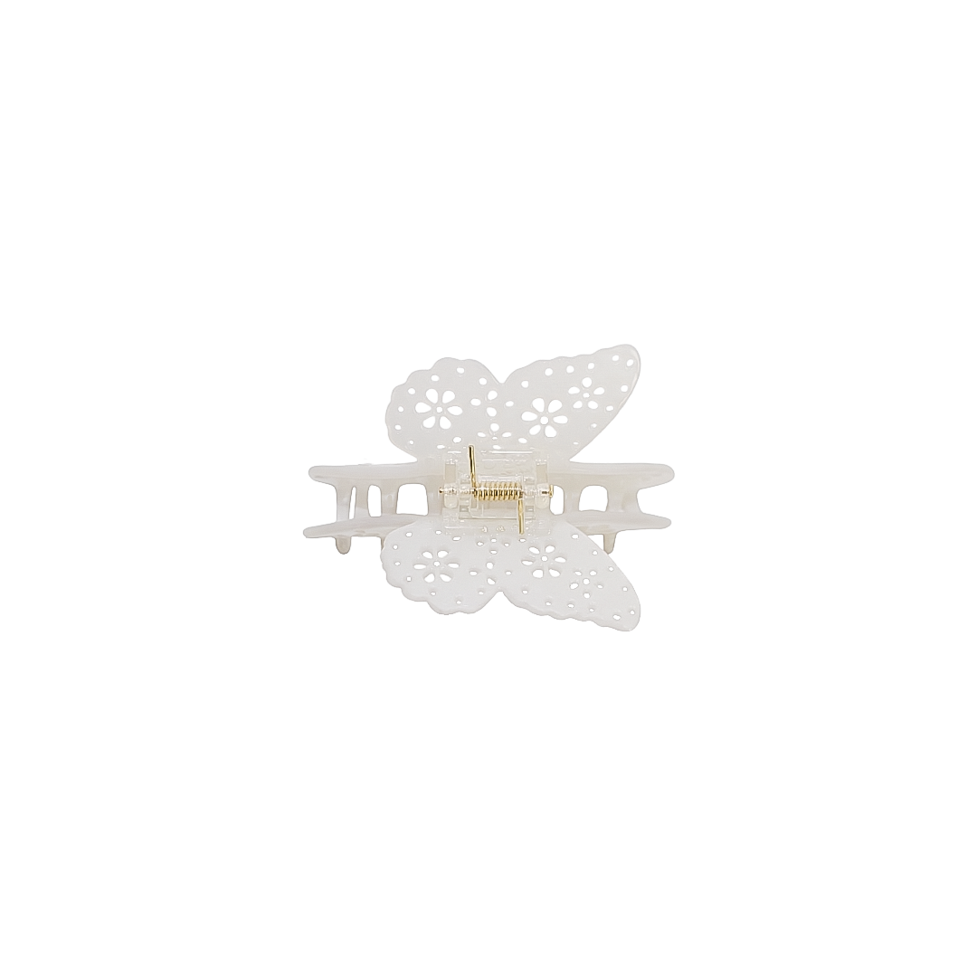 A white butterfly-shaped hair claw clip with delicate cutout details and a small gold metal spring in the center, shown on a plain white background.