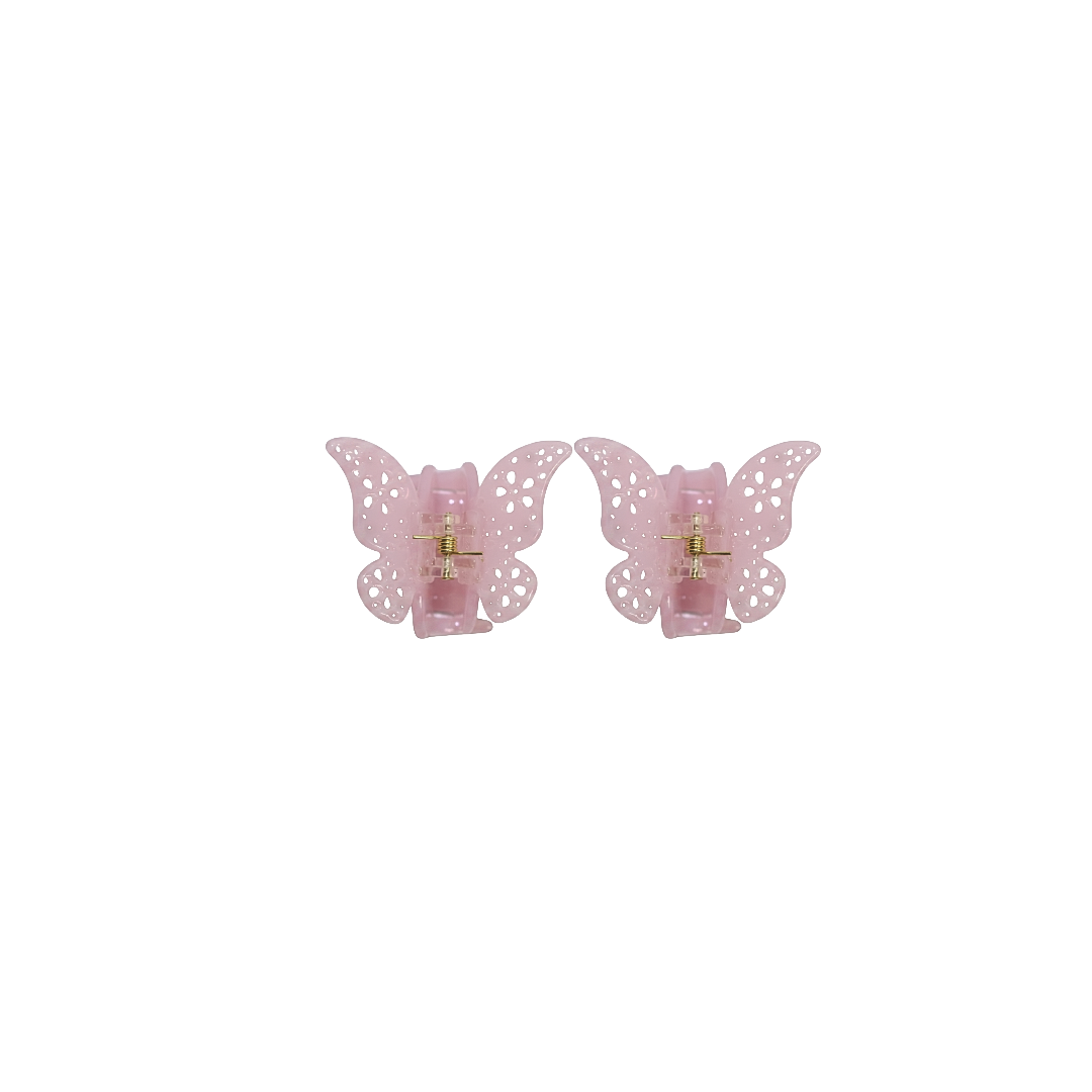 A pair of light pink butterfly-shaped hair claw clips with a perforated lace design and a gold-tone metal center, shown on a plain white background.